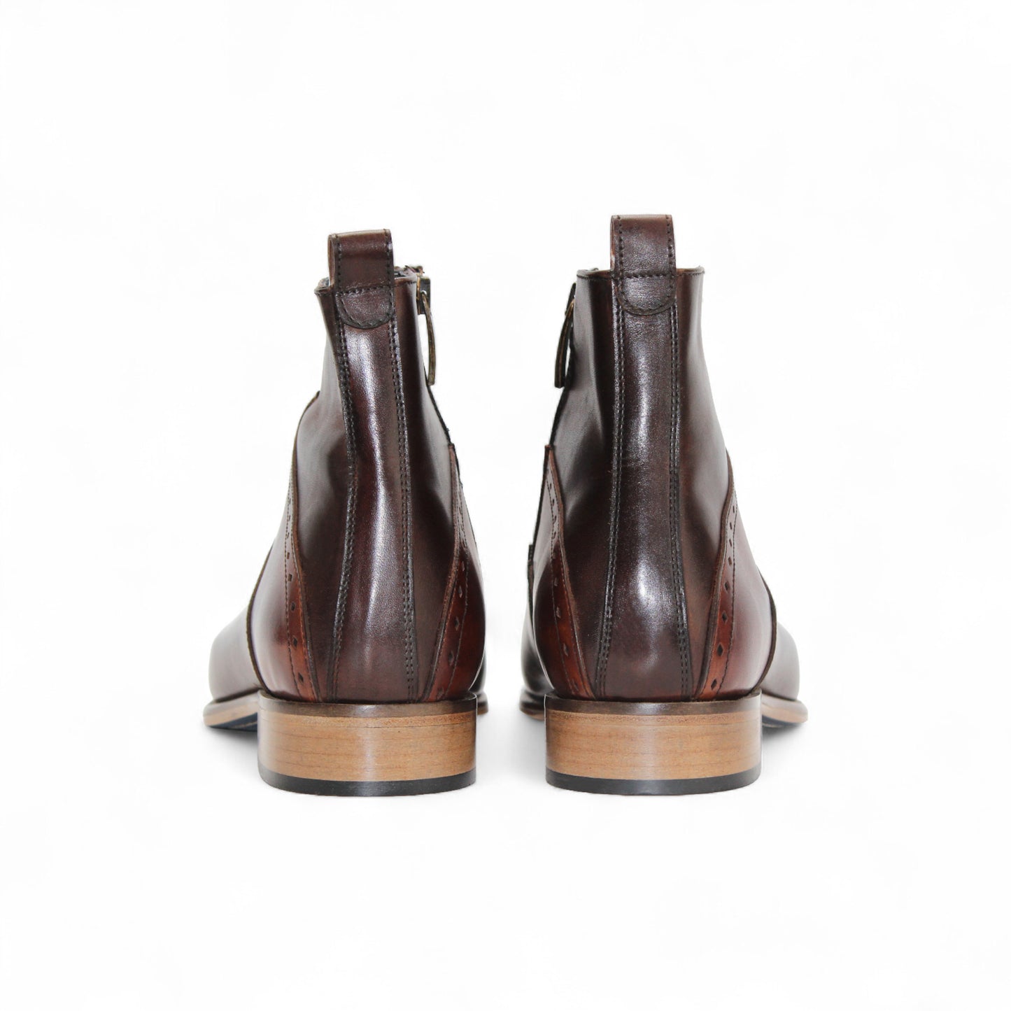 The Duca Di Matiste Duca Pedaso Chocolate/Brandy ankle boot features genuine leather, decorative stitching, a low wooden heel, and a side zipper for timeless style, shown here on a white background.