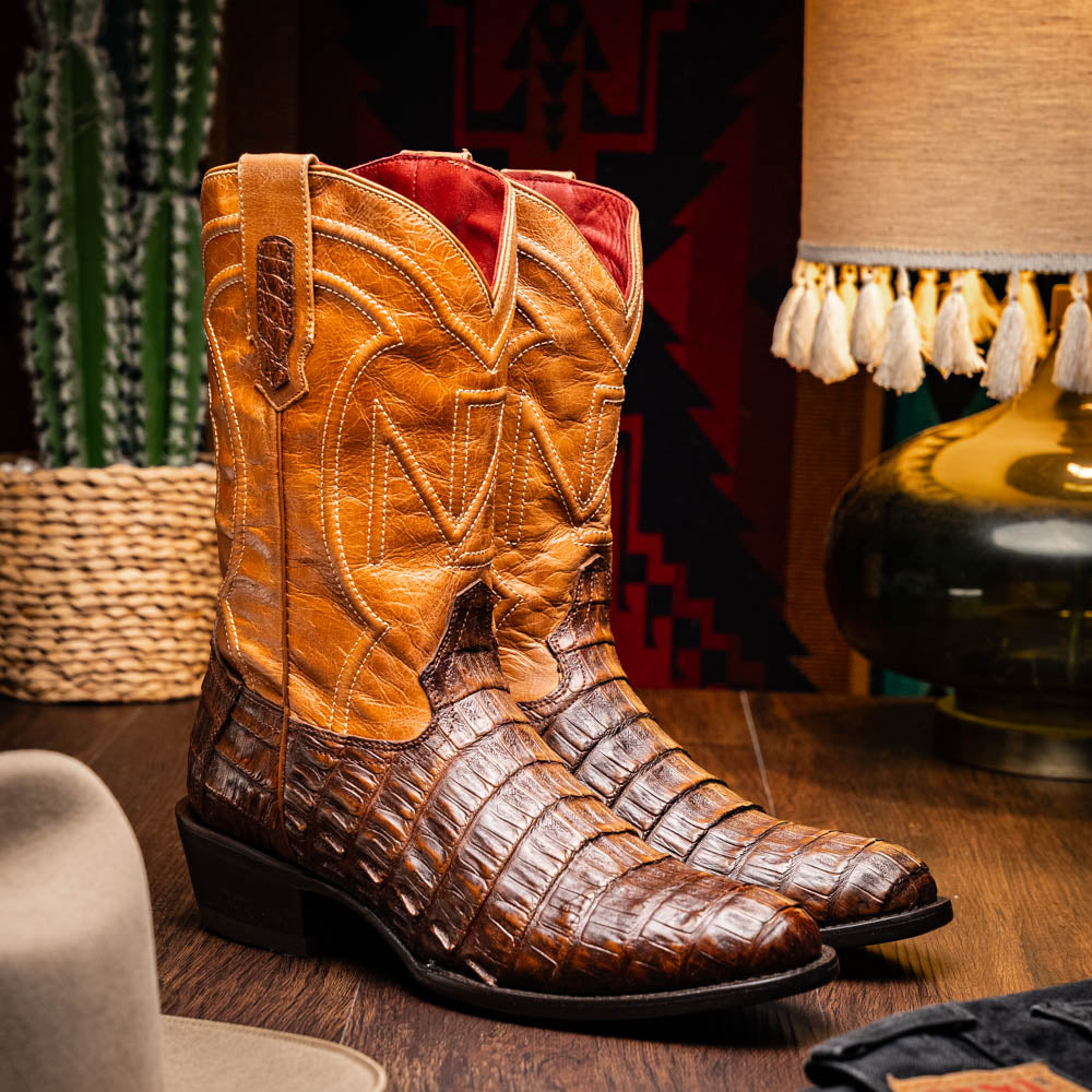 The Marco Di Milano Phoenix Aged Maple boots feature a textured brown full-grain leather foot, a lighter tan shaft, and display one boot upright while the other shows the branded sole.