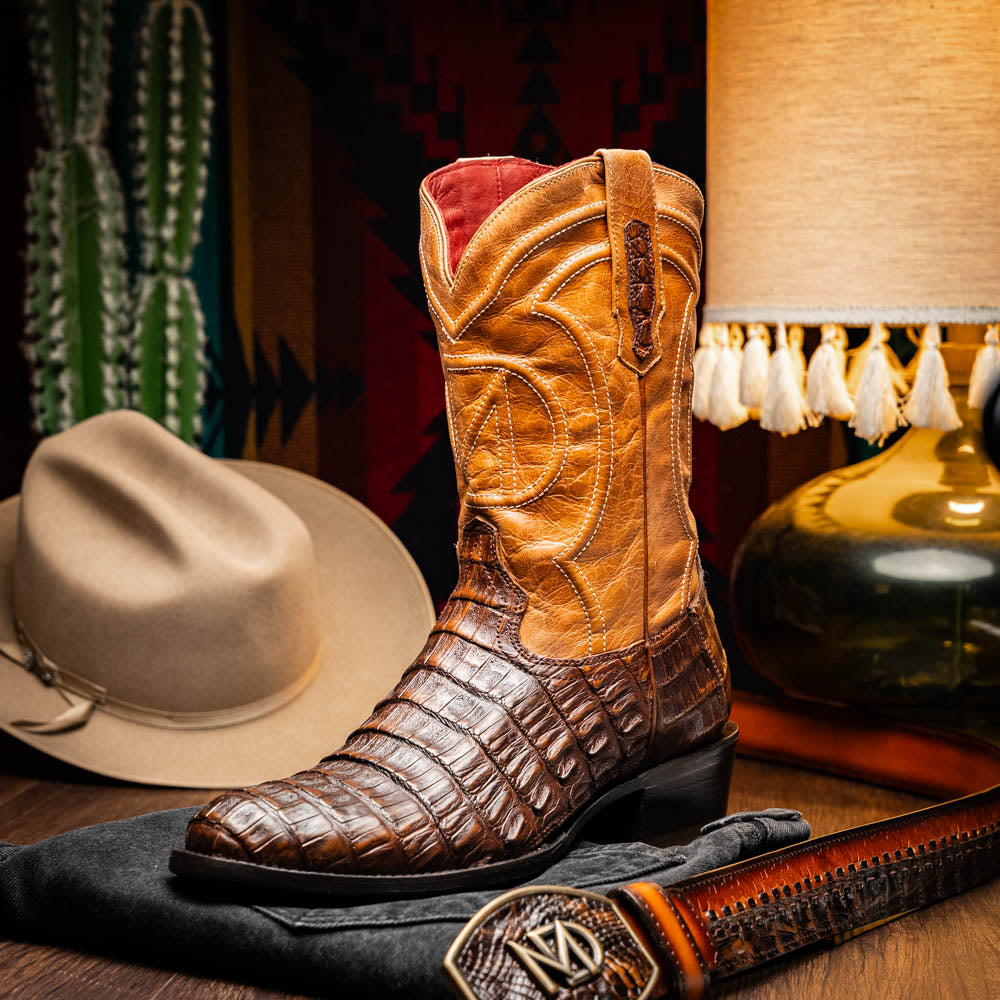 The Marco Di Milano Phoenix Aged Maple boots feature a textured brown full-grain leather foot, a lighter tan shaft, and display one boot upright while the other shows the branded sole.