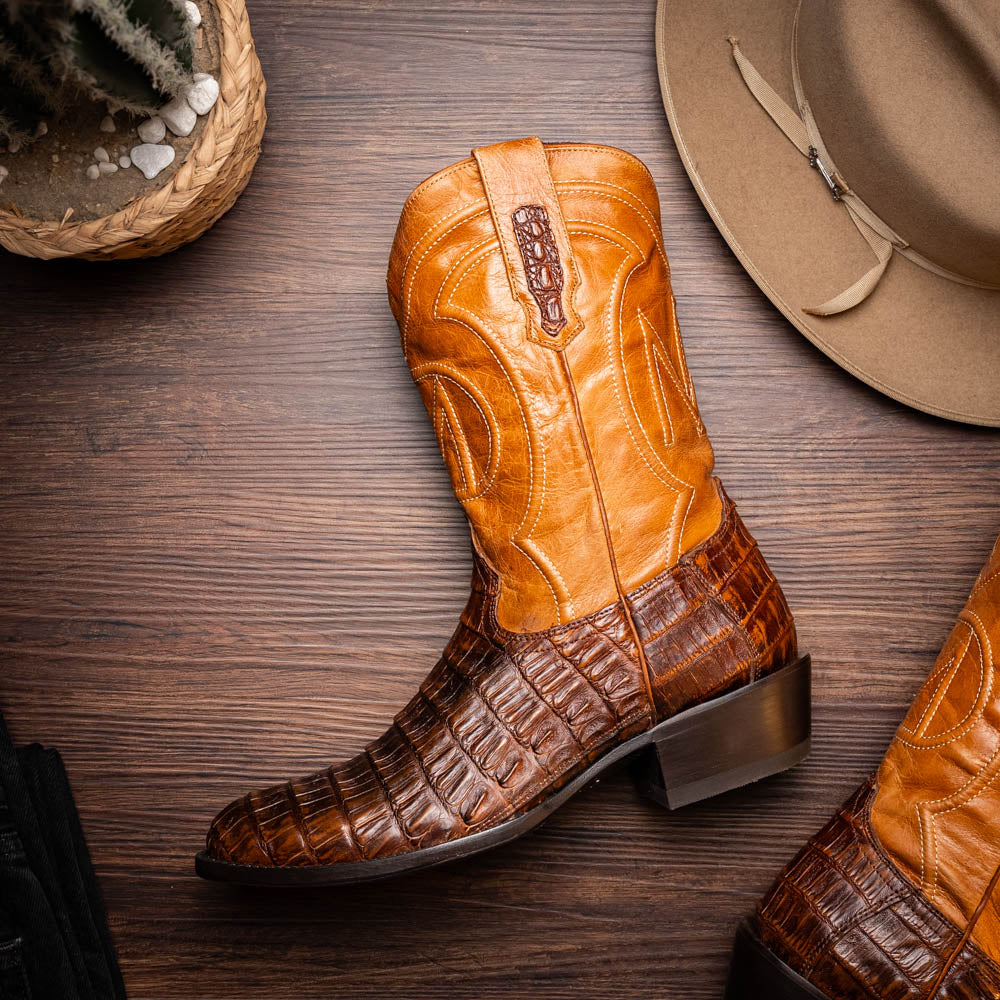 The Marco Di Milano Phoenix Aged Maple boots feature a textured brown full-grain leather foot, a lighter tan shaft, and display one boot upright while the other shows the branded sole.