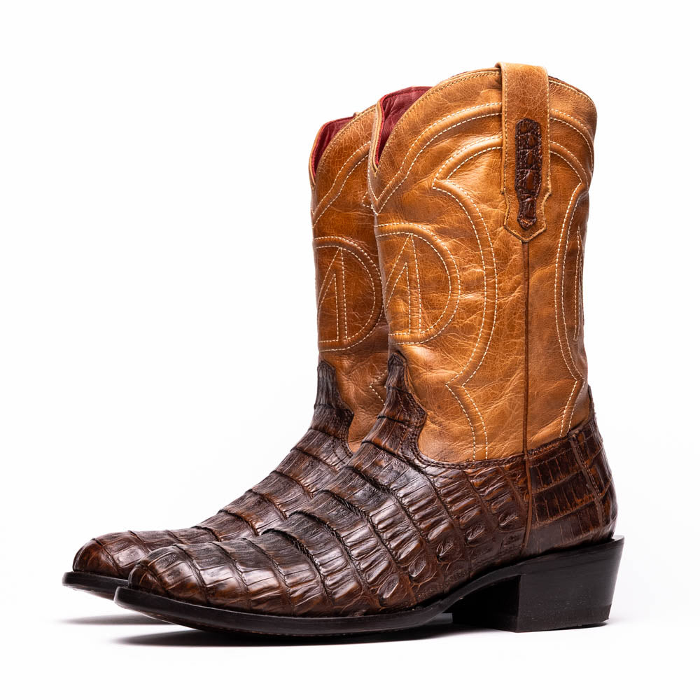 The Marco Di Milano Phoenix Aged Maple boots feature a textured brown full-grain leather foot, a lighter tan shaft, and display one boot upright while the other shows the branded sole.