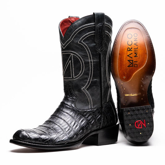 A pair of Phoenix Black Western cowboy boots by Marco Di Milano, one upright and one showing the sole, featuring a textured pattern and the brand name on the sole.