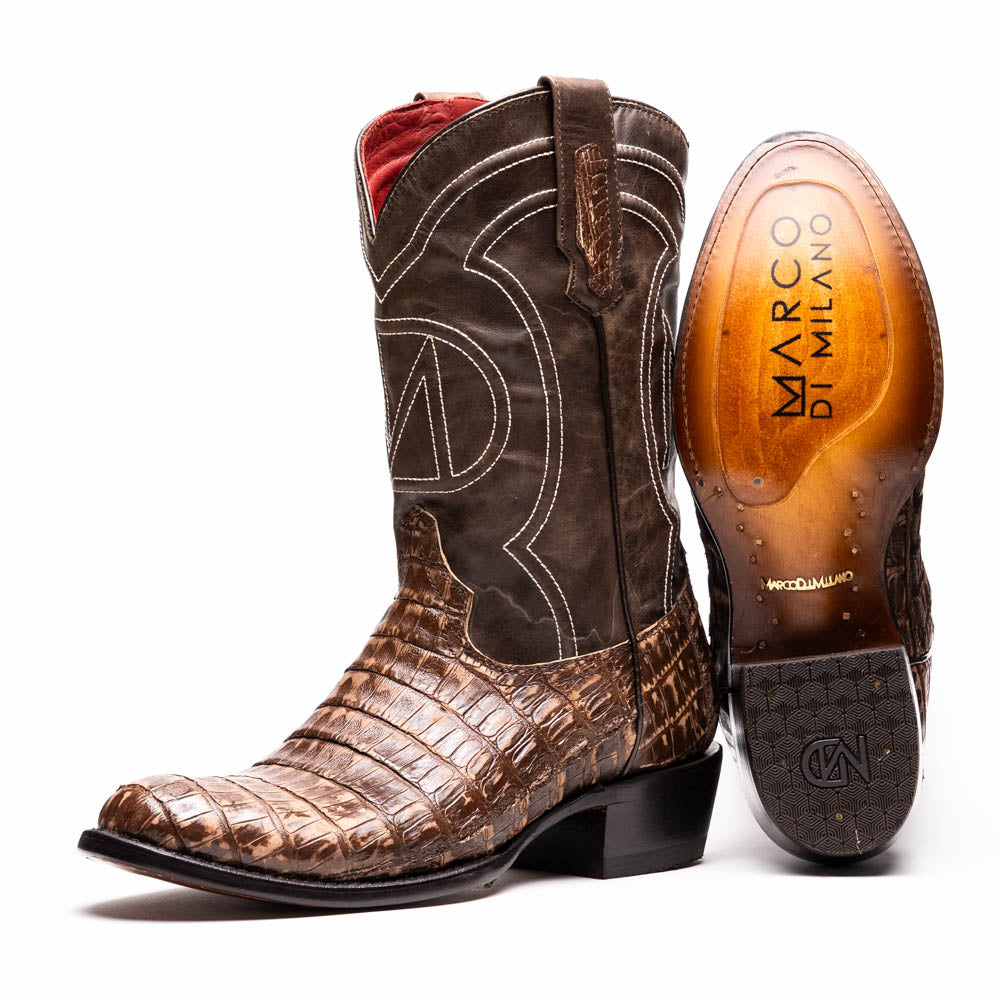 The Phoenix Stone Brown by Marco Di Milano are brown Western cowboy boots featuring crocodile-patterned textured leather, decorative stitching, and branded soles.