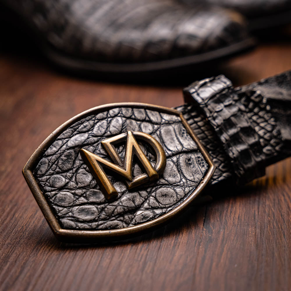 A pair of Phoenix Stone Gray cowboy boots by Marco Di Milano—one boot upright and the other displaying the branded sole.