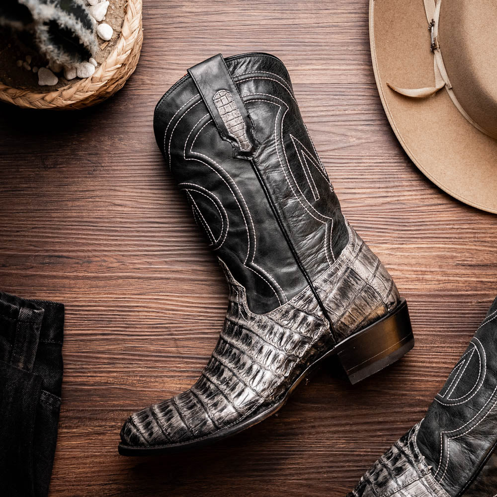 A pair of Phoenix Stone Gray cowboy boots by Marco Di Milano—one boot upright and the other displaying the branded sole.