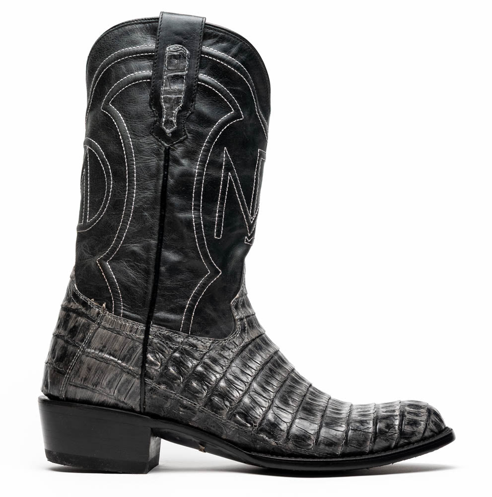 A pair of Phoenix Stone Gray cowboy boots by Marco Di Milano—one boot upright and the other displaying the branded sole.