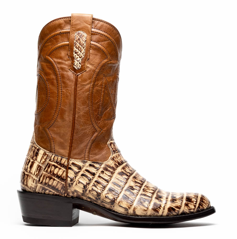 A pair of Phoenix Stone Orix brown Western cowboy boots by Marco Di Milano, featuring an alligator texture—one boot upright, the other displaying the sole with the brand logo.