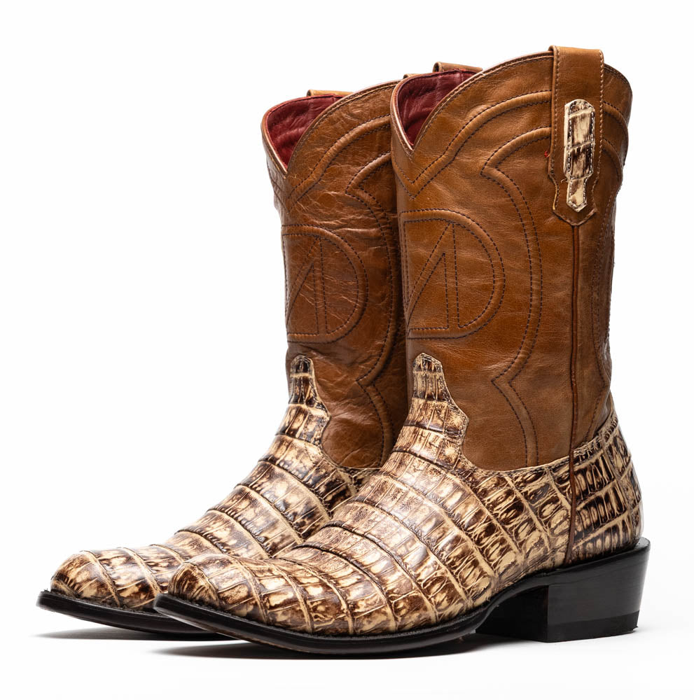 A pair of Phoenix Stone Orix brown Western cowboy boots by Marco Di Milano, featuring an alligator texture—one boot upright, the other displaying the sole with the brand logo.