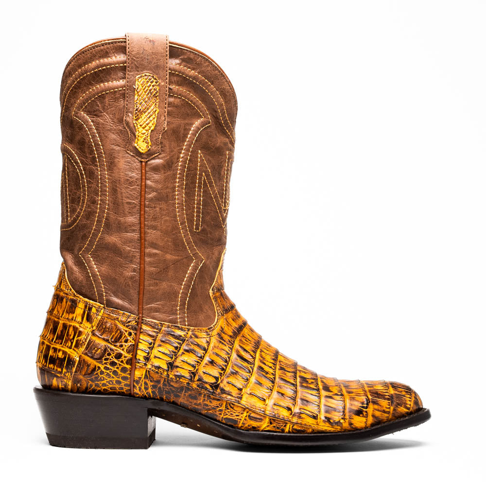 The Phoenix Mustard Brown by Marco Di Milano is a pair of Western boots in genuine caiman belly leather with a textured exotic finish and branded sole, shown against a white background.