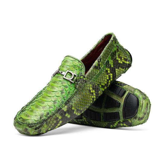 A pair of Marco Di Milano’s Pia Lemon Green driver shoes—crafted from green python skin with black soles and silver buckles—one upright and the other leaning gracefully, showcases the exquisite luxury of handcrafted men’s exotic footwear.
