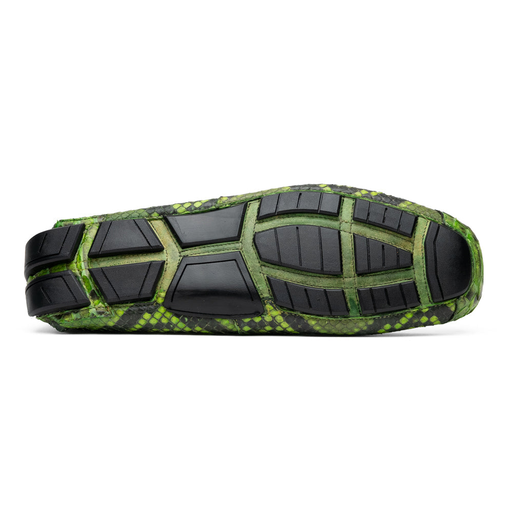 A pair of Marco Di Milano’s Pia Lemon Green driver shoes—crafted from green python skin with black soles and silver buckles—one upright and the other leaning gracefully, showcases the exquisite luxury of handcrafted men’s exotic footwear.