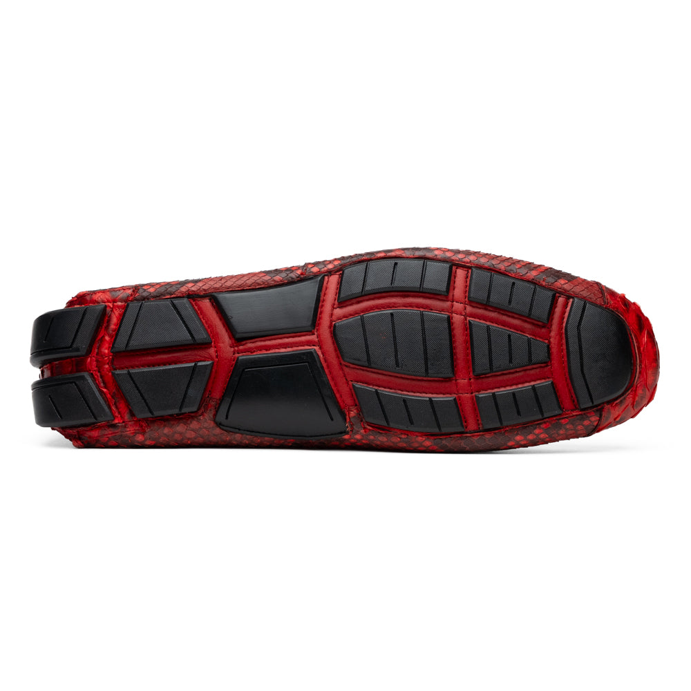 A pair of Pia Red loafers by Marco Di Milano—crafted as luxury men’s driver shoes in a striking red snakeskin pattern, featuring black rubber soles and silver buckle detailing, with one shoe upright and the other displayed on its side—showcase the allure of exotic python-inspired style in a distinguished design.