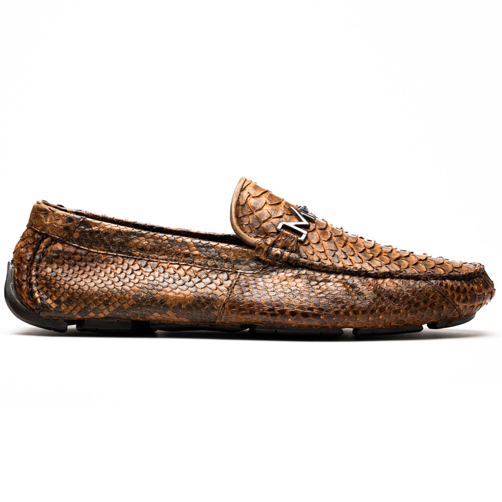 The Marco Di Milano Pia Cognac features brown python skin driver loafers with a metal buckle, visible black rubber soles, and one shoe upright while the other lies flat—a luxury men's shoe designed for style seekers.