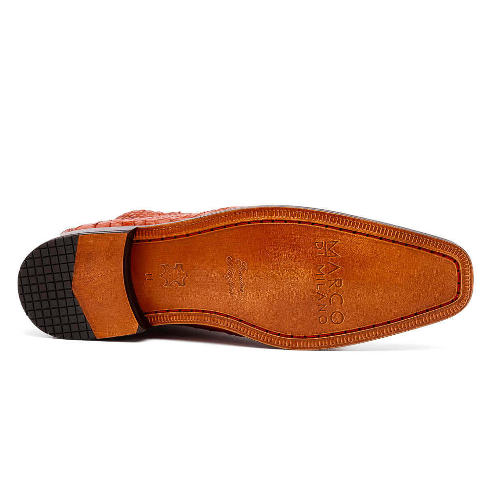 The Pietro Honey boots by Marco Di Milano are orange-brown genuine alligator, hand-painted with crocodile texture—displayed upright and sideway to show the sole—ideal for luxury footwear enthusiasts.