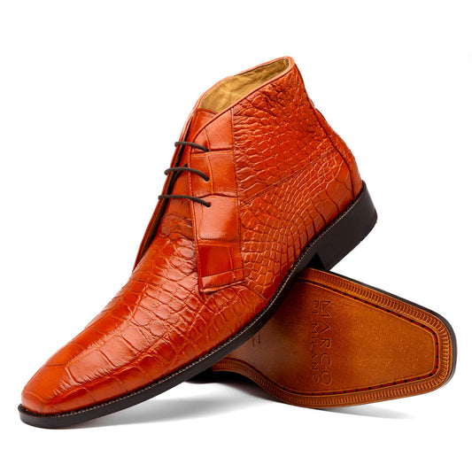 The Pietro Honey boots by Marco Di Milano are orange-brown genuine alligator, hand-painted with crocodile texture—displayed upright and sideway to show the sole—ideal for luxury footwear enthusiasts.