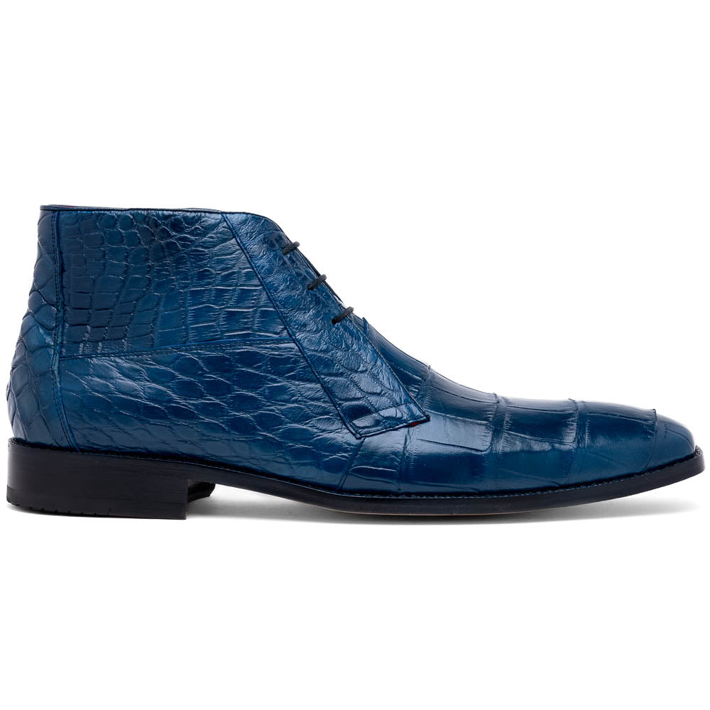 The Marco Di Milano "Pietro Blue Jeans" are luxury men's lace-up boots in blue crocodile-pattern leather, with one standing upright and the other tilted to reveal the tan embossed sole.