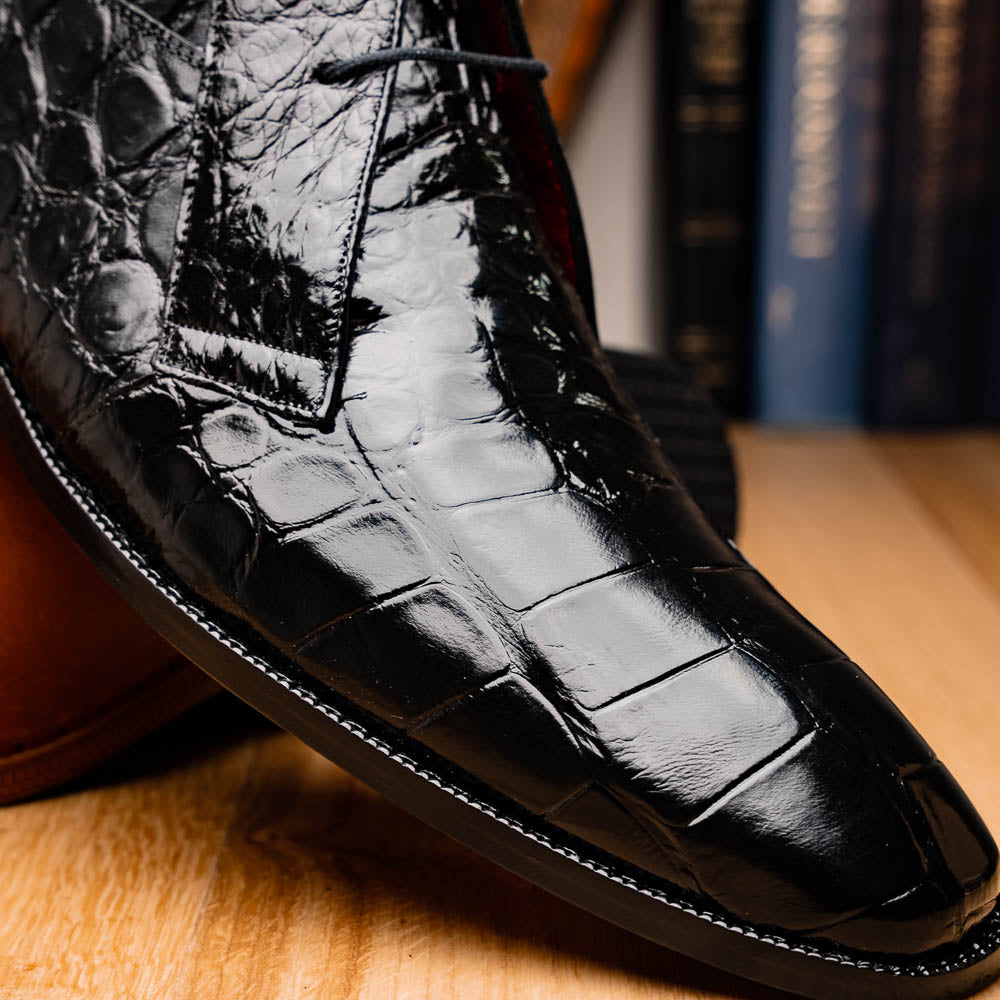 Experience luxury with Marco Di Milano's Pietro Black men's lace-up boots—crafted in black, crocodile-patterned leather with dark laces and brown leather soles.