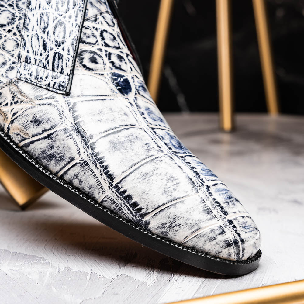 The Pietro Newspaper by Marco Di Milano: men's ankle-high dress boots with a white and black crocodile pattern, black laces, brown leather soles, and hand painted finishes—luxury footwear for a distinctive look.