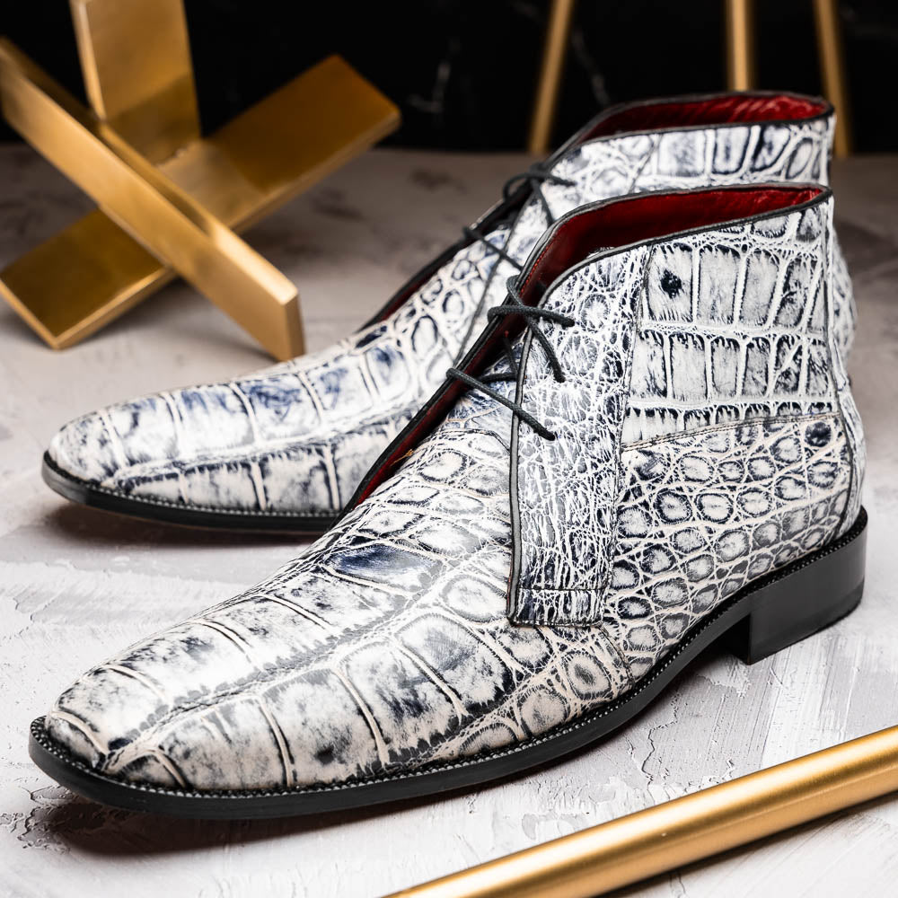 The Pietro Newspaper by Marco Di Milano: men's ankle-high dress boots with a white and black crocodile pattern, black laces, brown leather soles, and hand painted finishes—luxury footwear for a distinctive look.