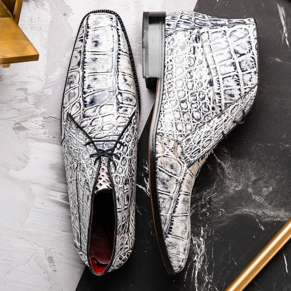 The Pietro Newspaper by Marco Di Milano: men's ankle-high dress boots with a white and black crocodile pattern, black laces, brown leather soles, and hand painted finishes—luxury footwear for a distinctive look.