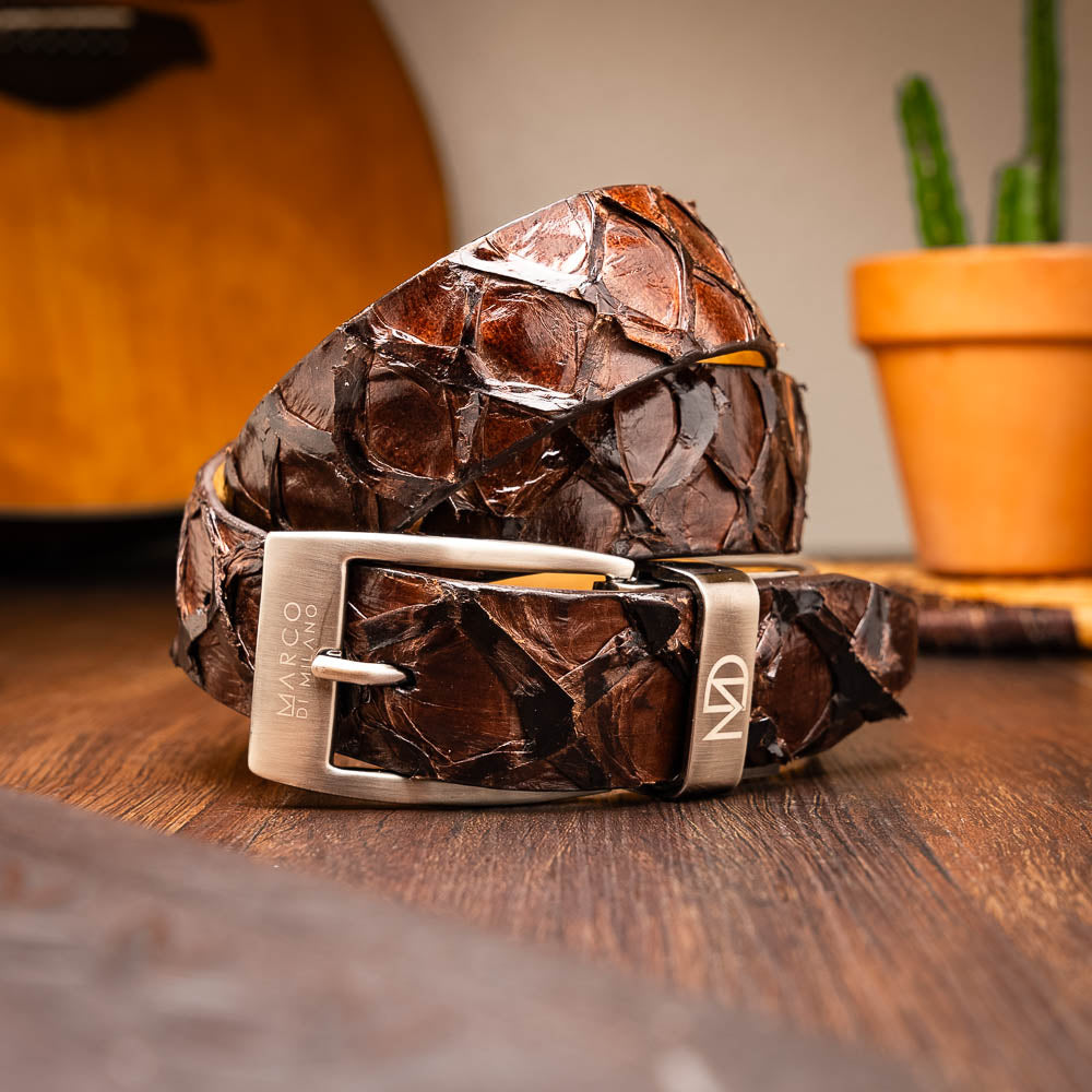 The Olivieri Belt Brown by Marco Di Milano is a genuine pirarucu leather belt with a textured finish, silver buckle, and "MD" initials—ideal for pairing with luxury footwear.