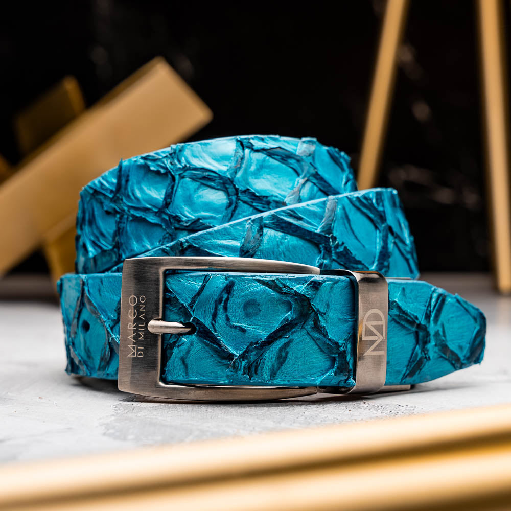 The Olivieri Belt Caribbean Blue by Marco Di Milano, made from genuine pirarucu with a textured turquoise finish and a silver logo buckle, is shown coiled on a white background.