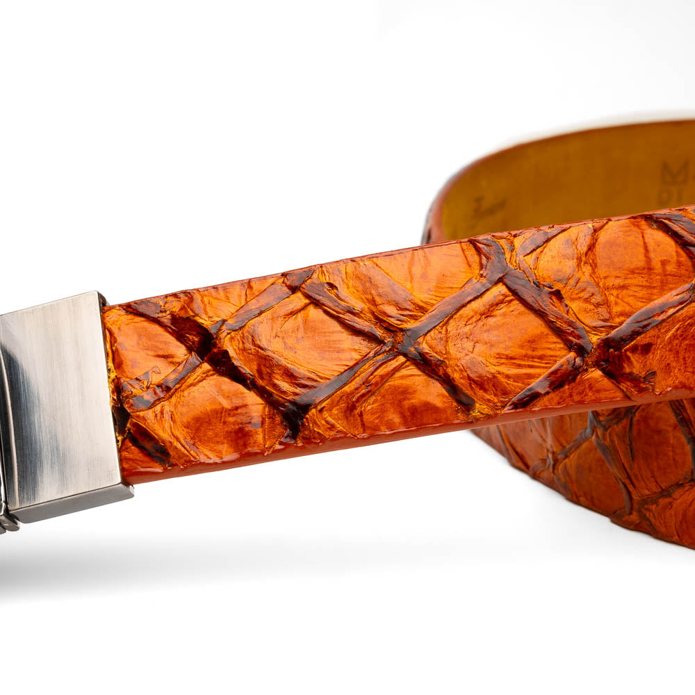 The Olivieri Belt Brandy by Marco Di Milano features brown textured genuine pirarucu leather and a silver buckle engraved with the brand's logo, coiled neatly against a white background.