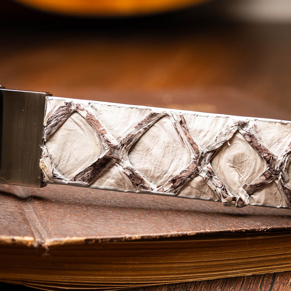 The Olivieri Belt Newspaper by Marco Di Milano features a beige and brown pattern, premium leather, and a silver buckle engraved with the brand logo—ideal for complementing luxury footwear.