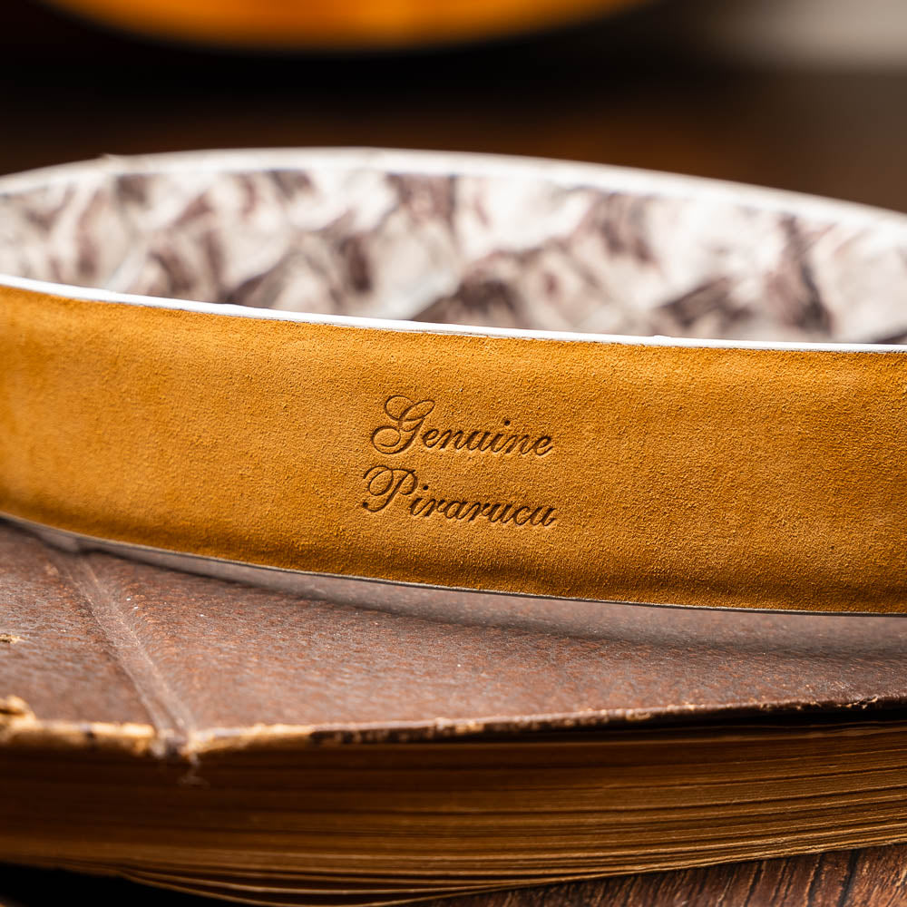 The Olivieri Belt Newspaper by Marco Di Milano features a beige and brown pattern, premium leather, and a silver buckle engraved with the brand logo—ideal for complementing luxury footwear.