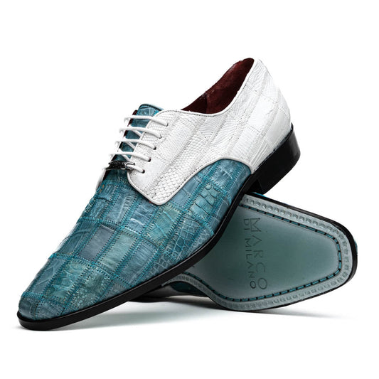 The "Pissa Aqua/White" by Marco Di Milano is a men's dress shoe with a white textured upper, teal blue patterned lower, hand-painted finishes, white laces, and a black sole—showcasing luxury style and craftsmanship.