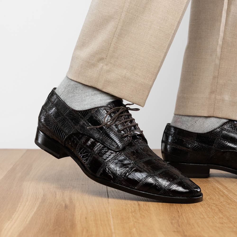 A pair of Marco Di Milano Pissa Brown textured leather dress shoes, with one shoe upright and the other on its side to showcase the sole.