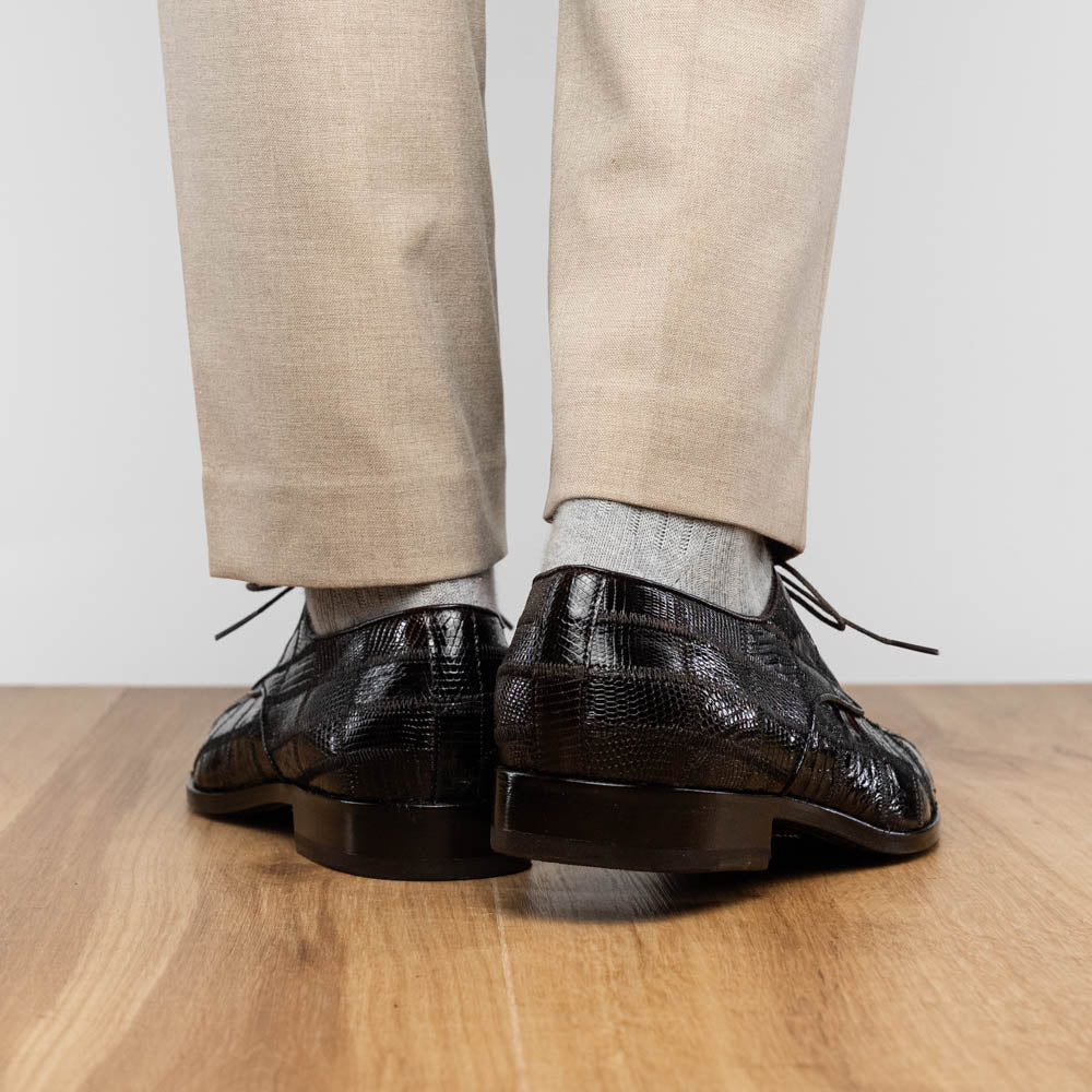 A pair of Marco Di Milano Pissa Brown textured leather dress shoes, with one shoe upright and the other on its side to showcase the sole.