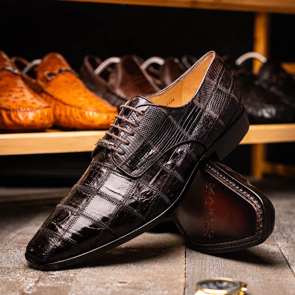A pair of Marco Di Milano Pissa Brown textured leather dress shoes, with one shoe upright and the other on its side to showcase the sole.