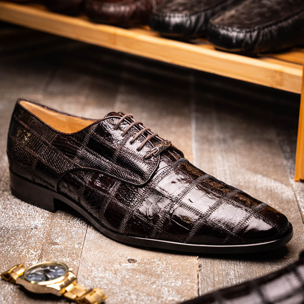 A pair of Marco Di Milano Pissa Brown textured leather dress shoes, with one shoe upright and the other on its side to showcase the sole.