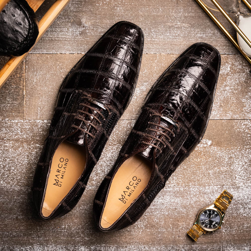 A pair of Marco Di Milano Pissa Brown textured leather dress shoes, with one shoe upright and the other on its side to showcase the sole.