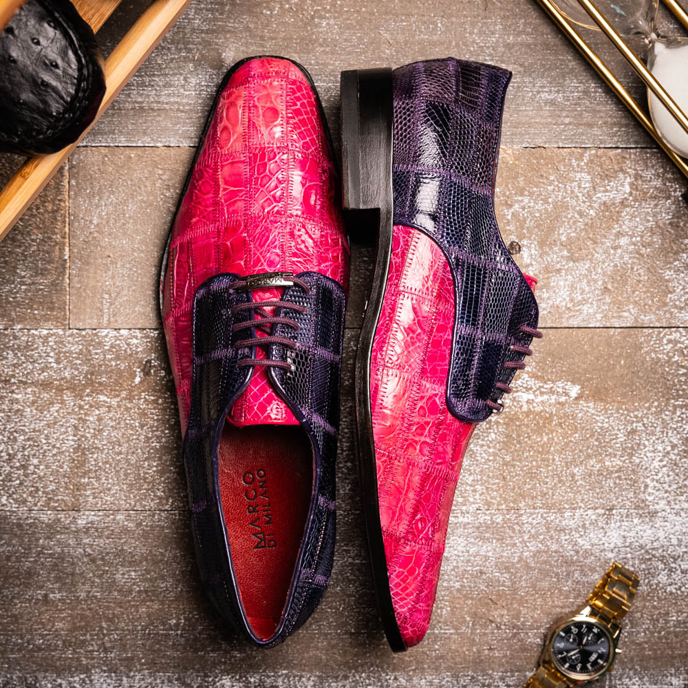 The Pissa Pink/Purple by Marco Di Milano are men's luxury dress shoes crafted from genuine exotics, featuring hand-painted pink and purple crocodile and lizard patterns—one shoe upright, the other on its side to display the sole.
