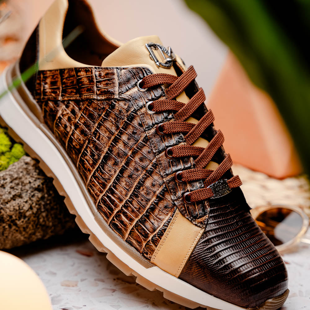 The Portici Orix / Brown by Marco Di Milano features a brown and tan faux crocodile texture, brown laces, white midsole, and a tan-brown rubber sole, delivering luxury style on a white background.