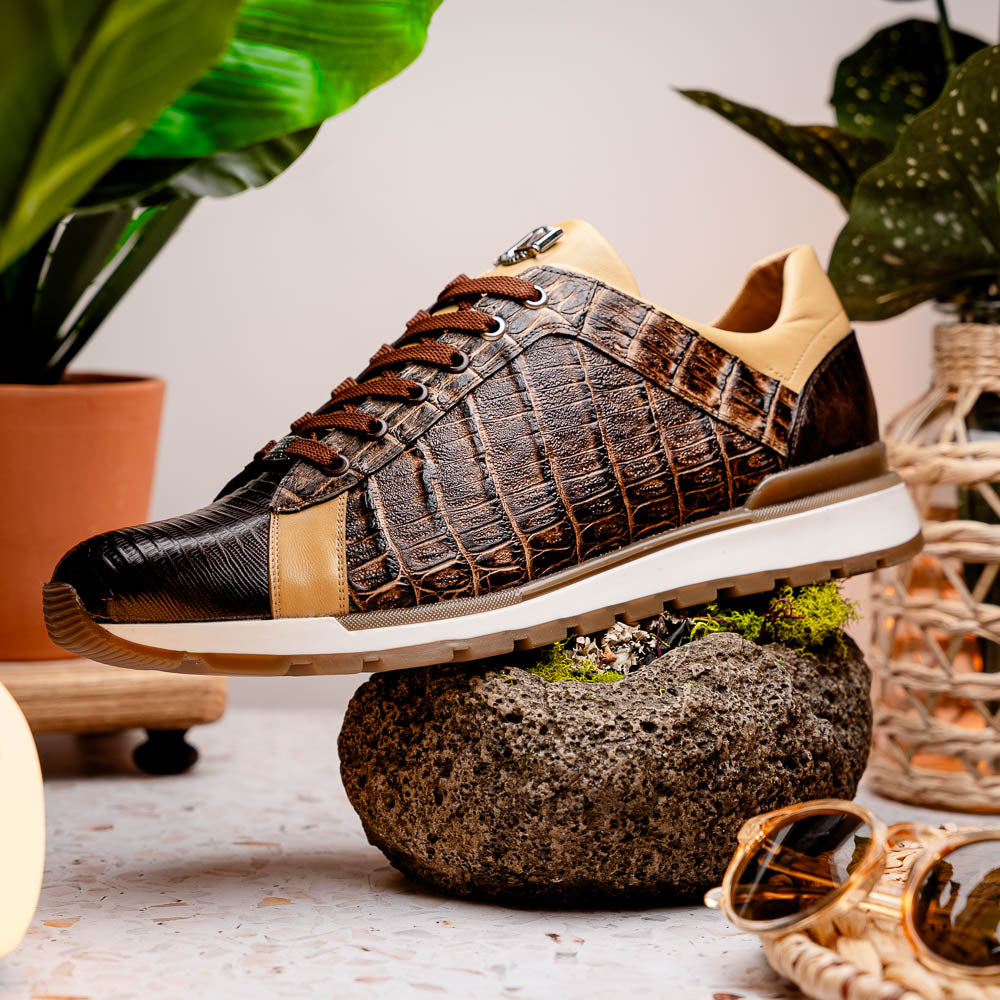 The Portici Orix / Brown by Marco Di Milano features a brown and tan faux crocodile texture, brown laces, white midsole, and a tan-brown rubber sole, delivering luxury style on a white background.