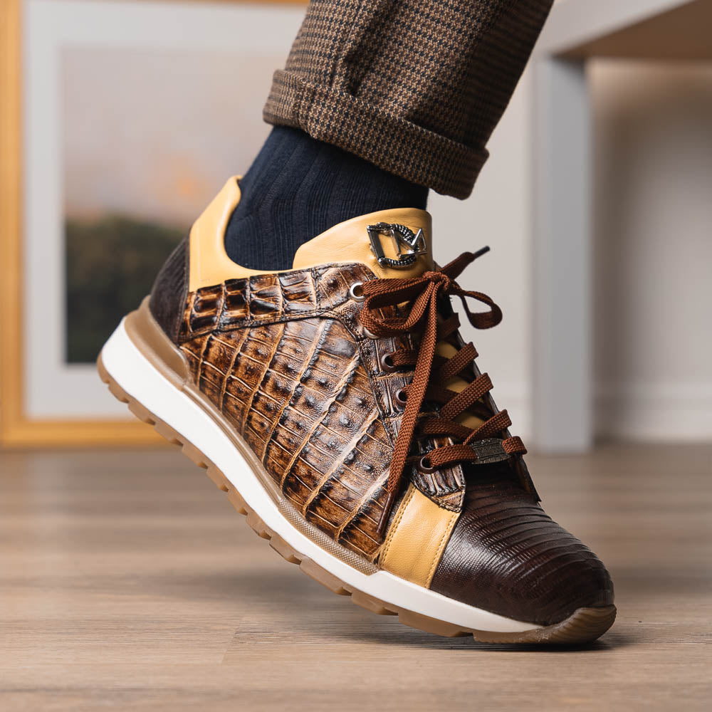 The Portici Orix / Brown by Marco Di Milano features a brown and tan faux crocodile texture, brown laces, white midsole, and a tan-brown rubber sole, delivering luxury style on a white background.