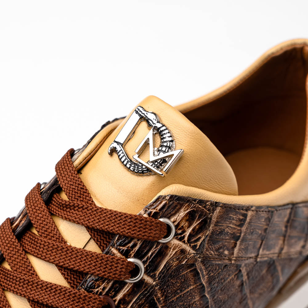 The Portici Orix / Brown by Marco Di Milano features a brown and tan faux crocodile texture, brown laces, white midsole, and a tan-brown rubber sole, delivering luxury style on a white background.