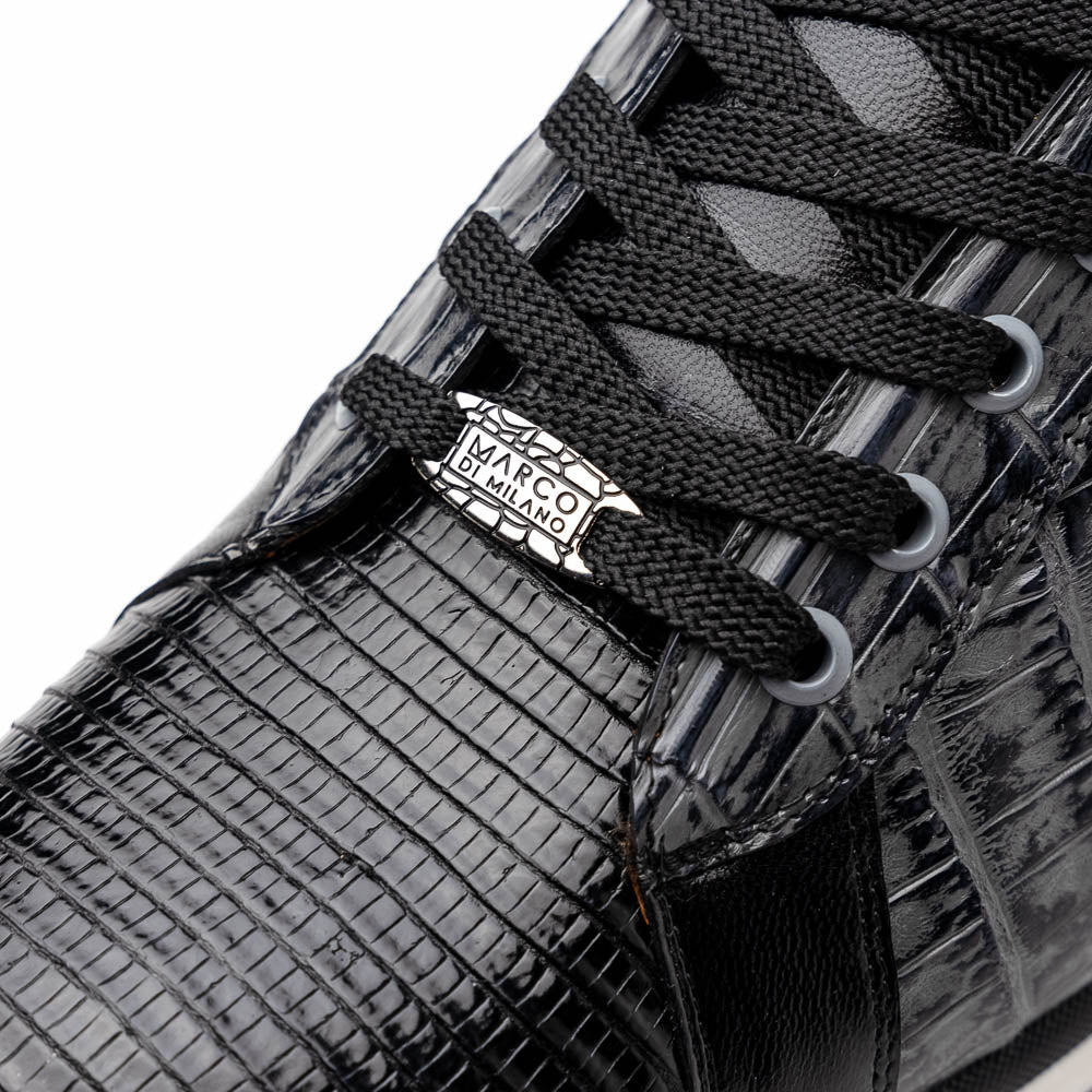 The Marco Di Milano Portici Gray / Black sneaker features black textured leather, black laces, and a white-trimmed rubber sole—one shoe upright and the other on its side—offering luxury footwear with a refined finish.