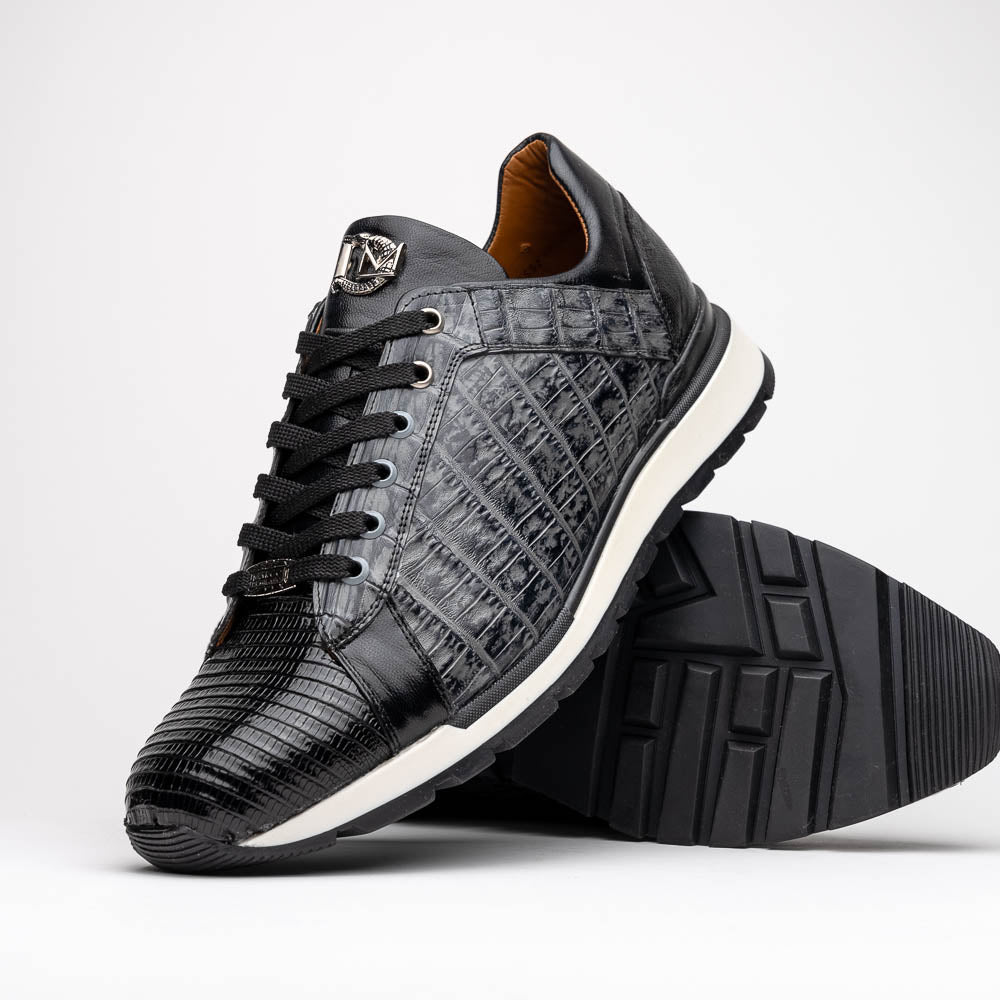 The Marco Di Milano Portici Gray / Black sneaker features black textured leather, black laces, and a white-trimmed rubber sole—one shoe upright and the other on its side—offering luxury footwear with a refined finish.