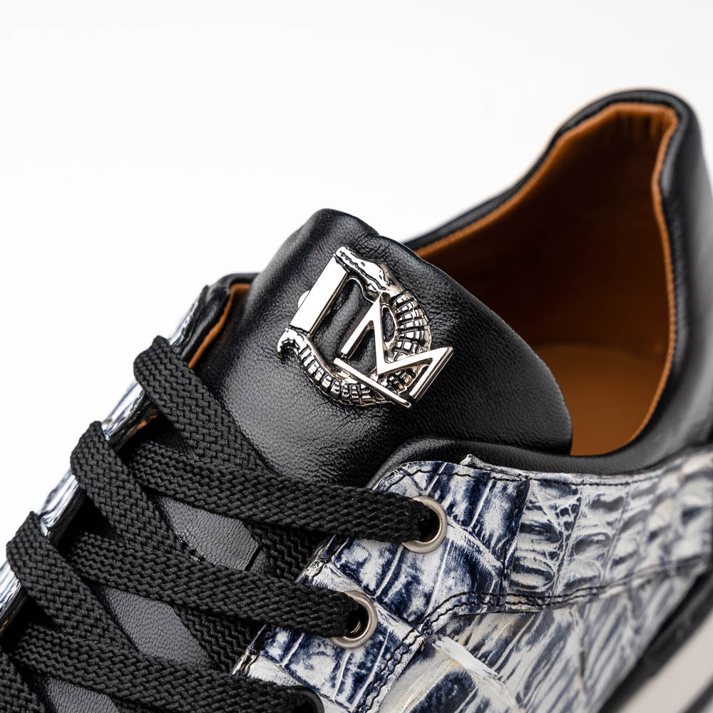 The Marco Di Milano Portici Newspaper / Black sneakers feature genuine crocodile leather in black and white with textured details and thick rubber soles, shown on a white background.