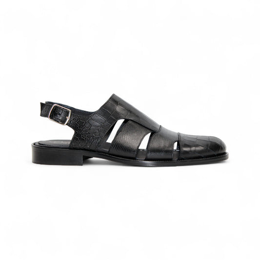 The Duca Di Matiste Duca Positano Black sandal features black leather, a closed toe, cut-out sides, buckled slingback strap, and flat sole—Italian craftsmanship—shown in profile on a white background.