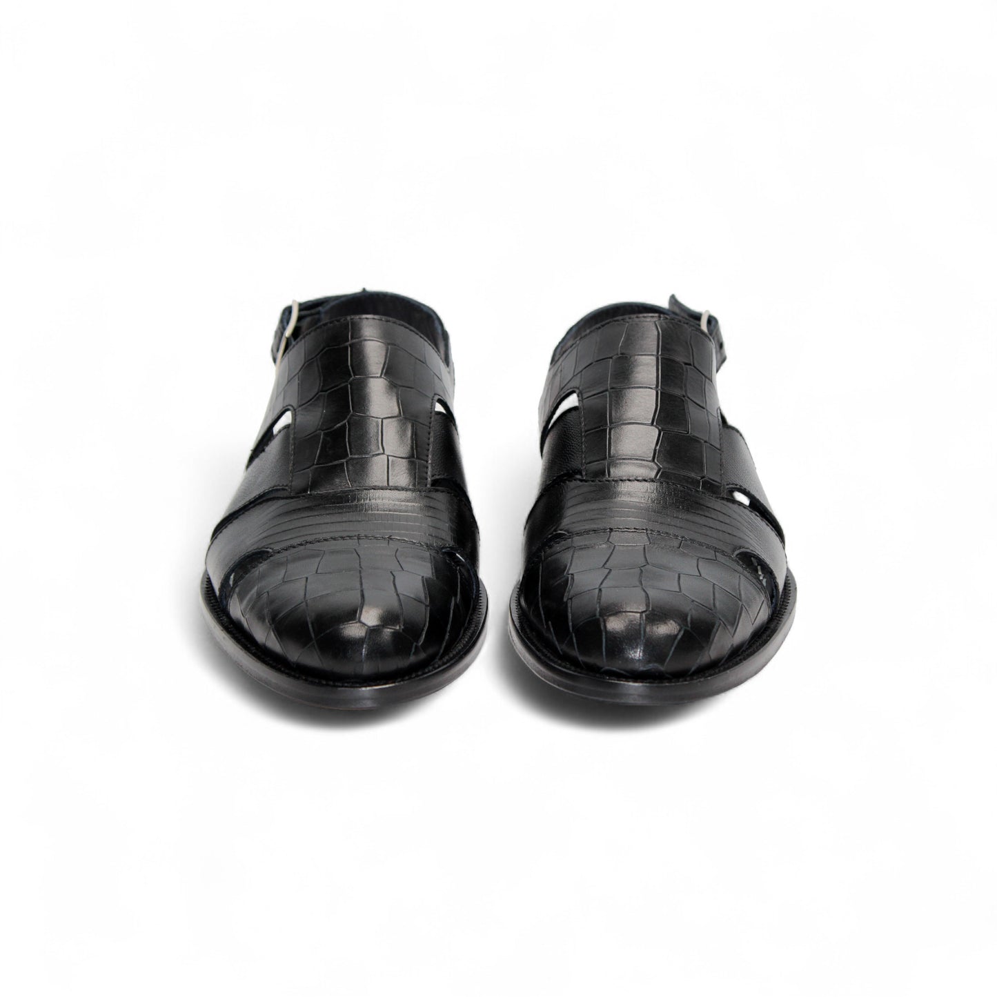 The Duca Di Matiste Duca Positano Black sandal features black leather, a closed toe, cut-out sides, buckled slingback strap, and flat sole—Italian craftsmanship—shown in profile on a white background.