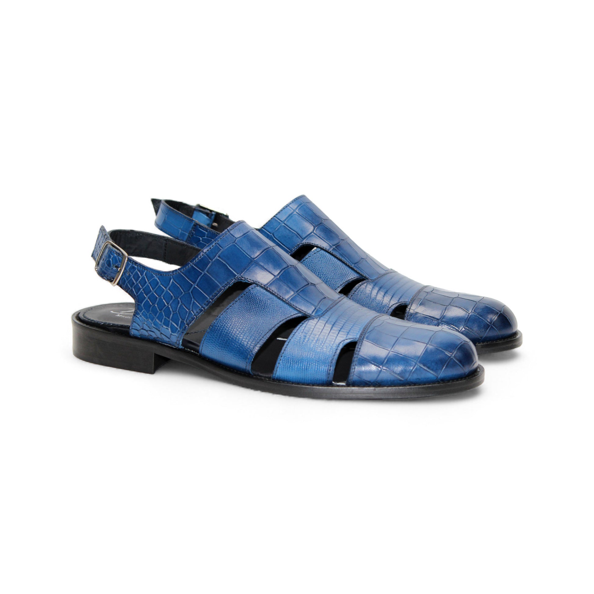 The Duca Di Matiste Duca Positano Ocean Blue is a closed-toe sandal with cut-out sides, an adjustable heel strap, and textured leather, showcasing Italian craftsmanship against a white background.