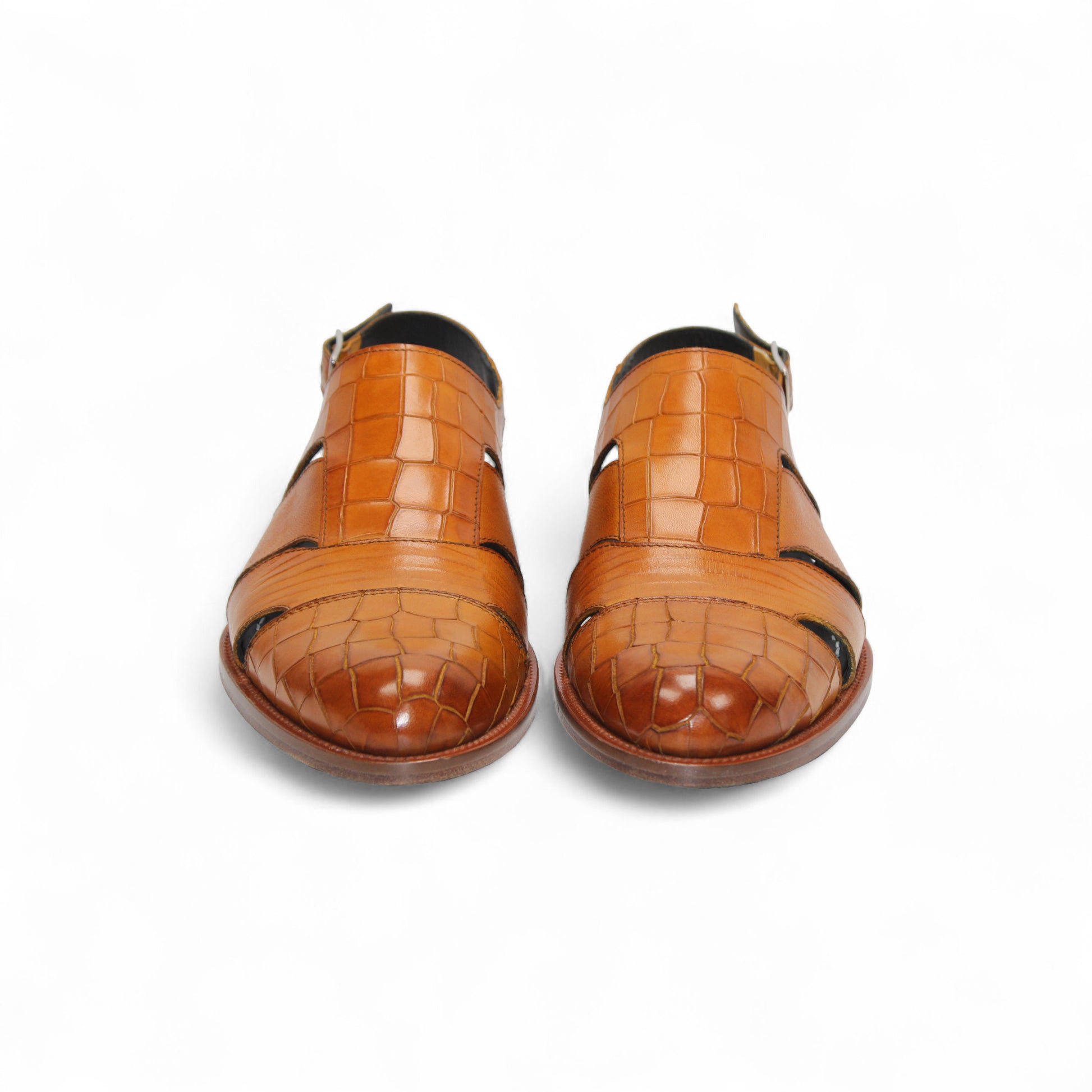 The Duca Di Matiste Positano (Cognac) is a brown croco embossed leather sandal with closed toe, cut-out sides, slingback strap with buckle, a textured pattern, and flat sole. Expertly crafted in Italy by Duca Di Matiste.