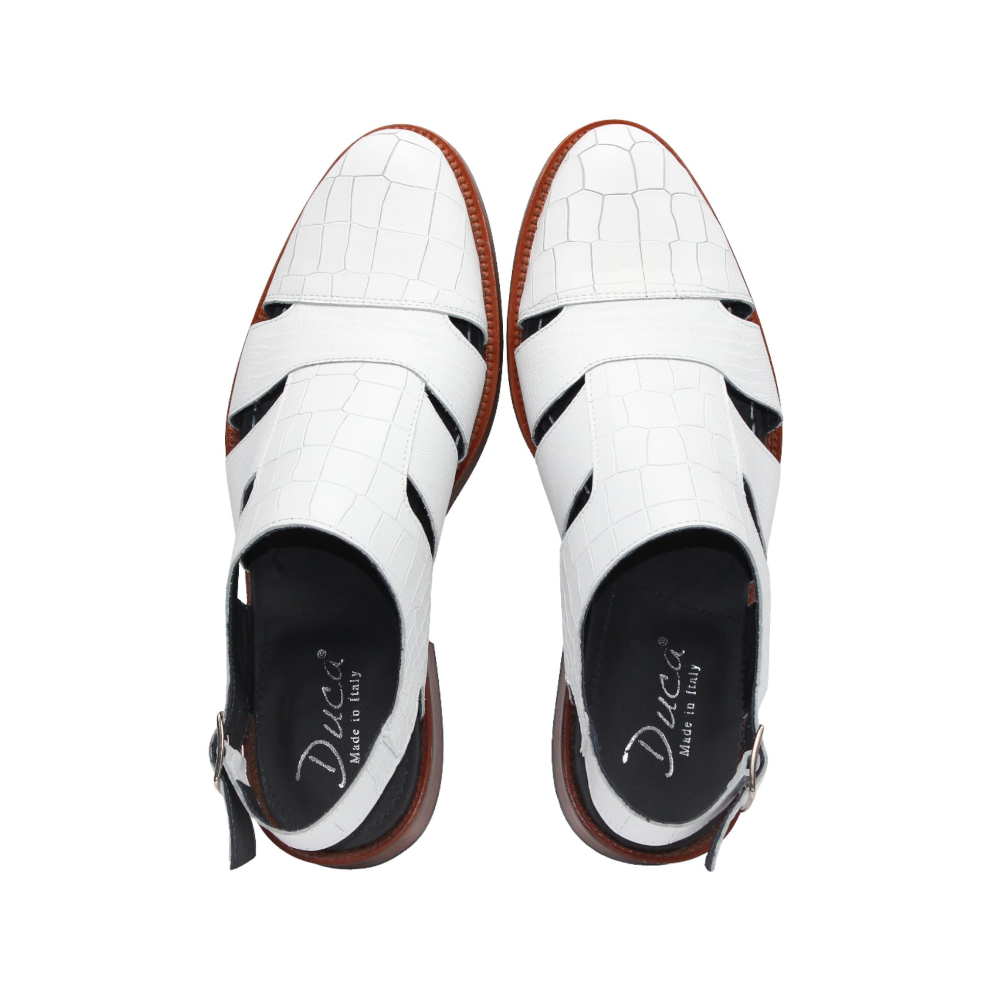 The Duca Di Matiste Positano (White) sandal by Duca Di Matiste features white croco leather, a closed toe, cutout sides, ankle strap with buckle, and brown sole, shown on a plain white background.