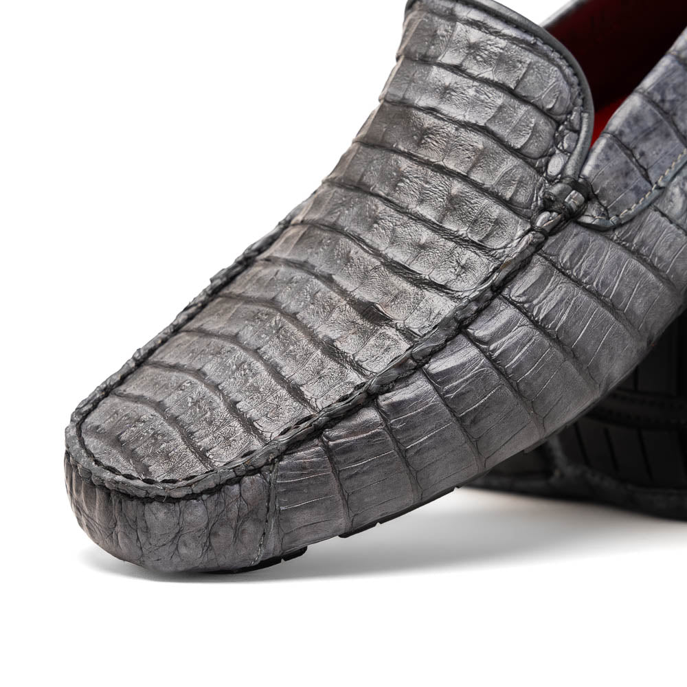 The Remo Gray driving loafers by Marco Di Milano feature a textured gray upper and rubber sole, with one shoe upright and the other leaning—ideal for genuine exotic footwear enthusiasts.