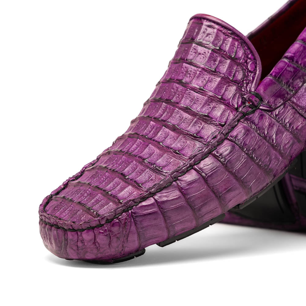 The Remo Purple by Marco Di Milano: a pair of crocodile-patterned purple leather driving loafers, one upright and one on its side revealing the black rubber sole—luxury men's footwear at its finest.